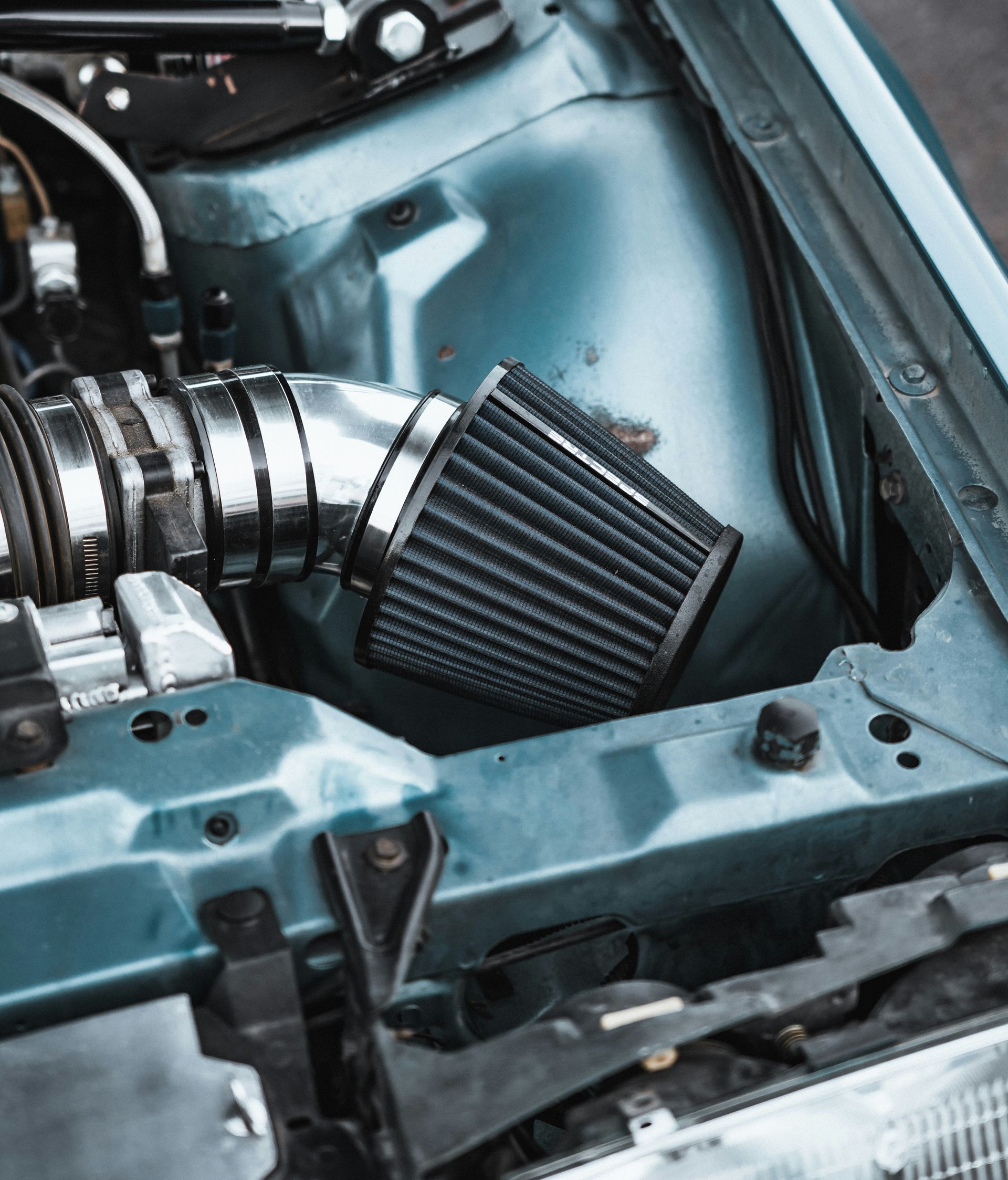 a close up of a car engine with the hood up